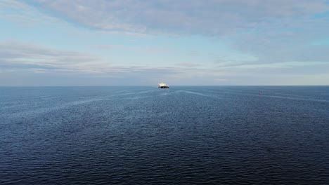 drone captures a ship moving through the baltic sea, leaving a gentle wake, 4k