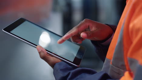 hands scrolling tablet screen at manufacture company closeup. modern technology