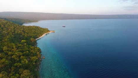 aerial footage of moyo island, sumbawa, indonesia travel destination tropical paradise with ocean sand beach and wild green tree jungle vegetation