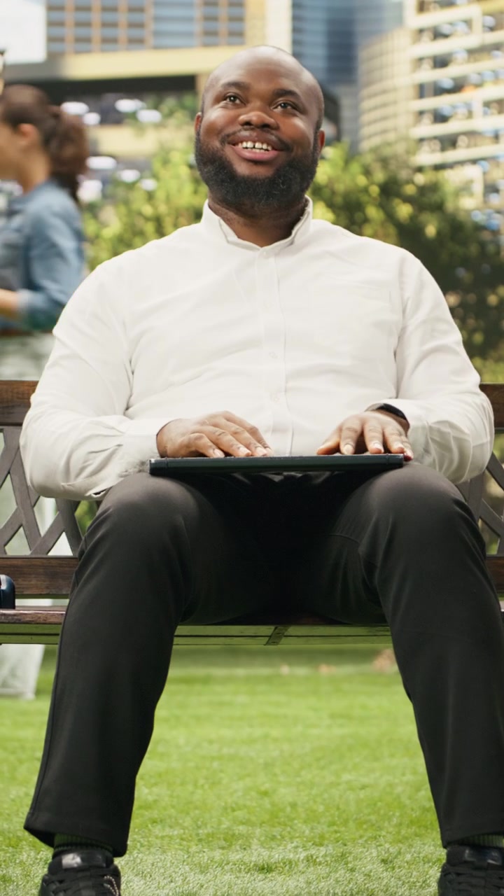Vertical Video Pleased businessman closing laptop and finishing daily work
