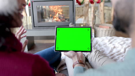 happy diverse couple having christmas tablet video call with green screen, slow motion