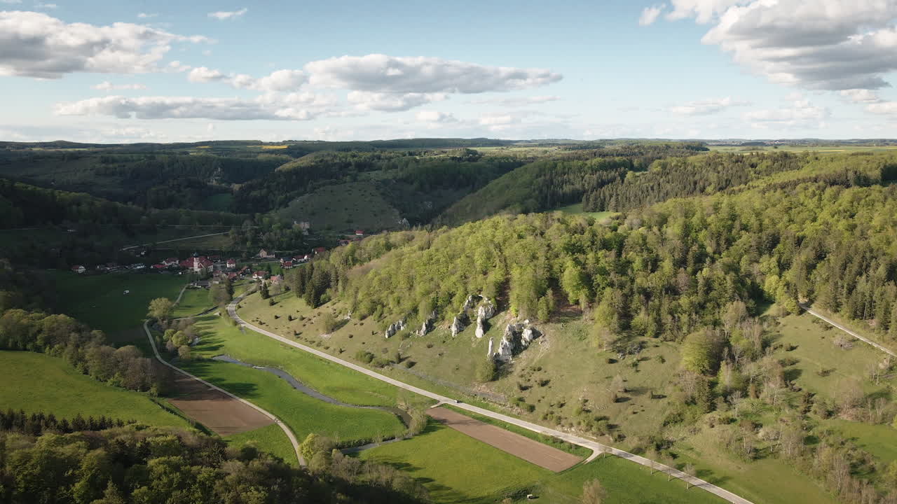 Jevn 4K UHD drone-push-in som flyr fremover over Große Lautertal-dalen, forbi kalksteinsklipper, enger og skogkledde skråninger i Schwäbische Alb