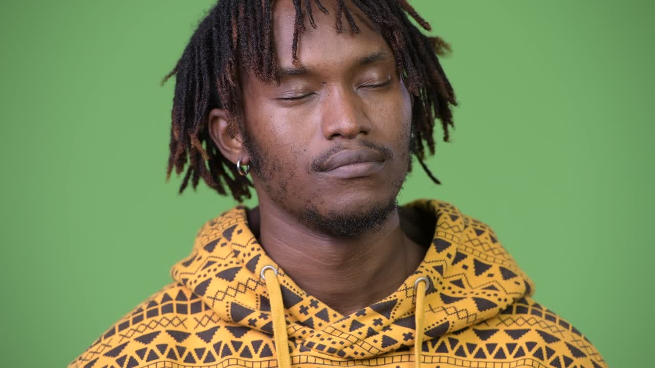 Young handsome African man relaxing with eyes closed