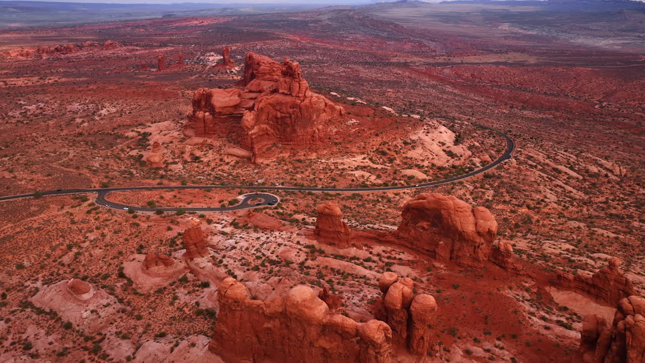 Droneflyvning tæt på motorvejen med observationsdæk i Arches Nationalpark i Utah, USA. Flyvning over den klippefyldte ørken ved solnedgang