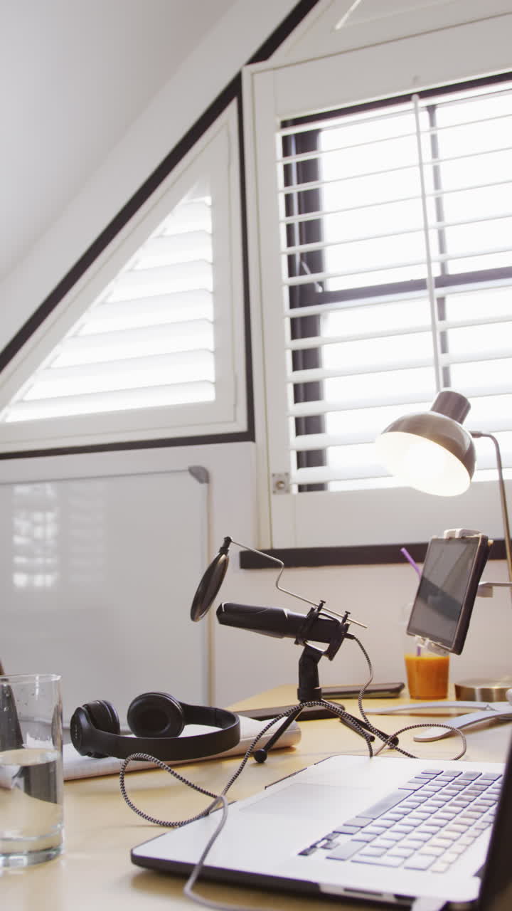 Vertical video of empty room at home with laptop and video equipment on table