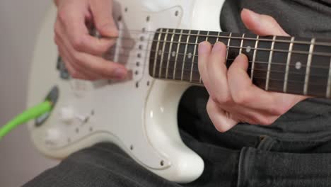 Plano-Medio-De-Un-Hombre-Tocando-Solos-De-Guitarra,-Acordes-Y-Ritmo-Con-Bajo-En-Un-Estudio-Centrado-En-Las-Manos