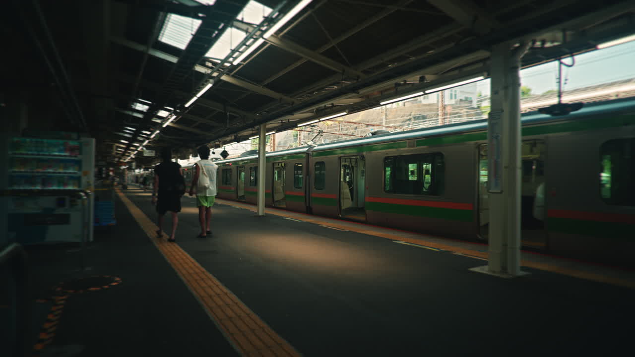 A train at a platform with people