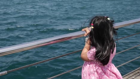 young girl looking out at the ocean