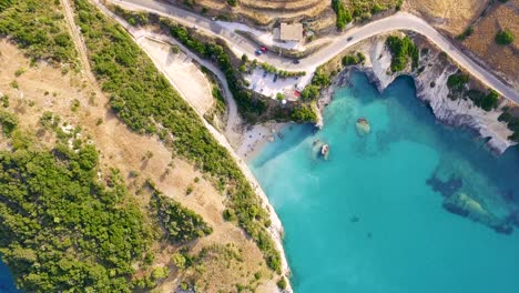 xigia beach in zakynthos, greece with turquoise waters and winding roads, aerial view