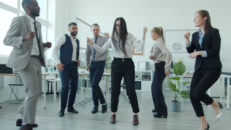 business team dancing in the office