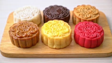 colourful chinese moon cake with mixed flavour on wood plate