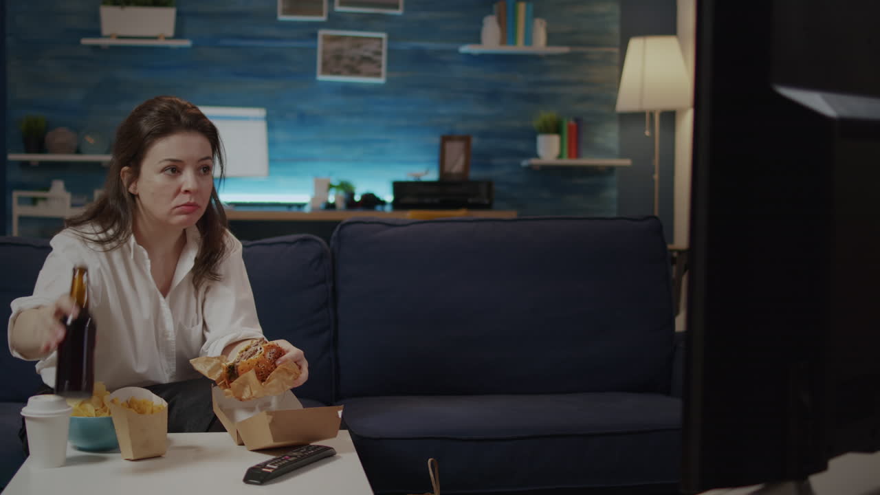 Caucasian woman eating hamburger from delivery bag