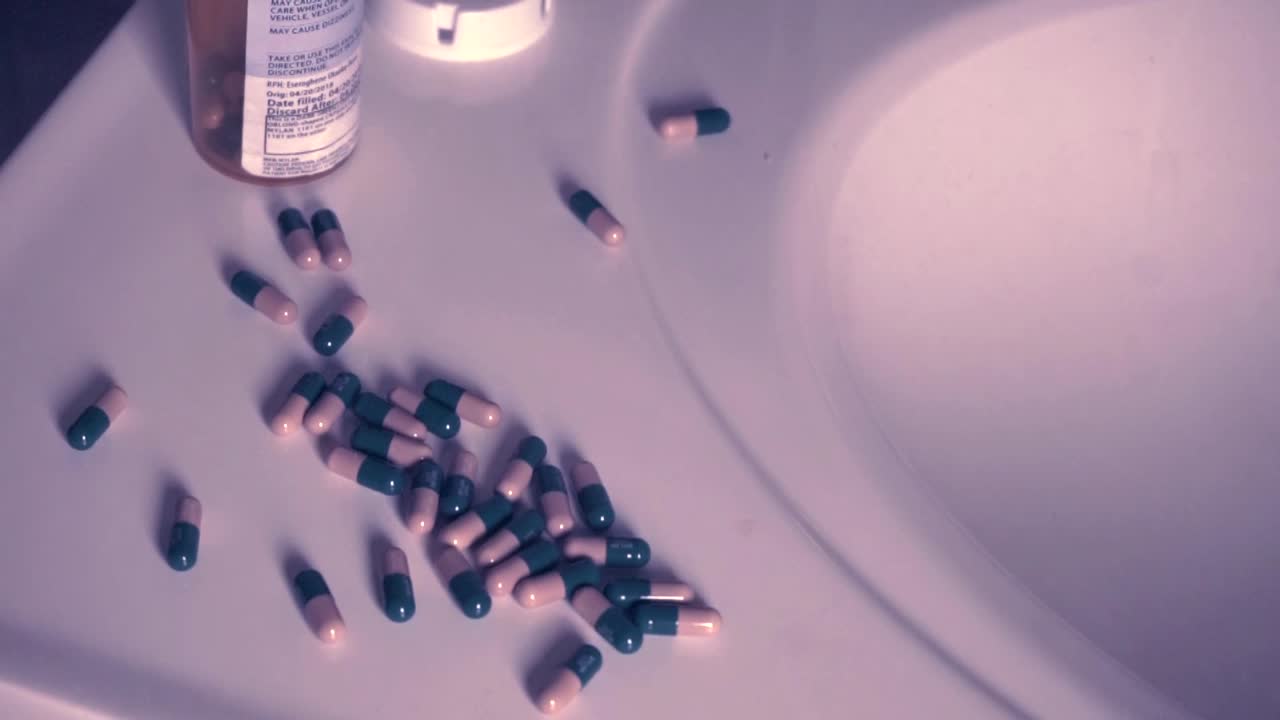 African American female hands angrily pushes pills into sink in despair