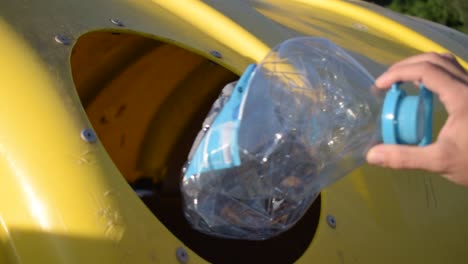 recycling a plastic bottle into a yellow bin