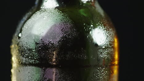 a glass bottle of cold beer condensate droplets appeared on the surface 4k 10 bit video