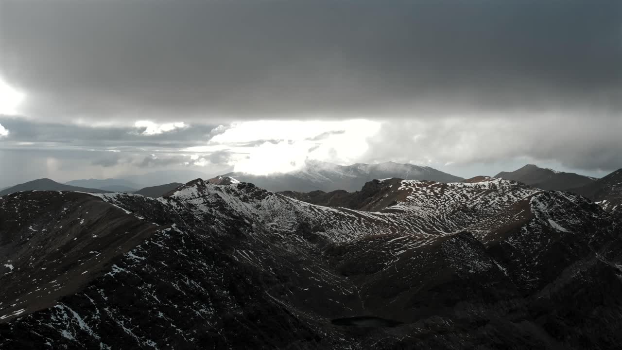 4K timelapse of Puigmal peak in the Catalan Pyrenees, showing snow-dusted ridges under dramatic moving clouds