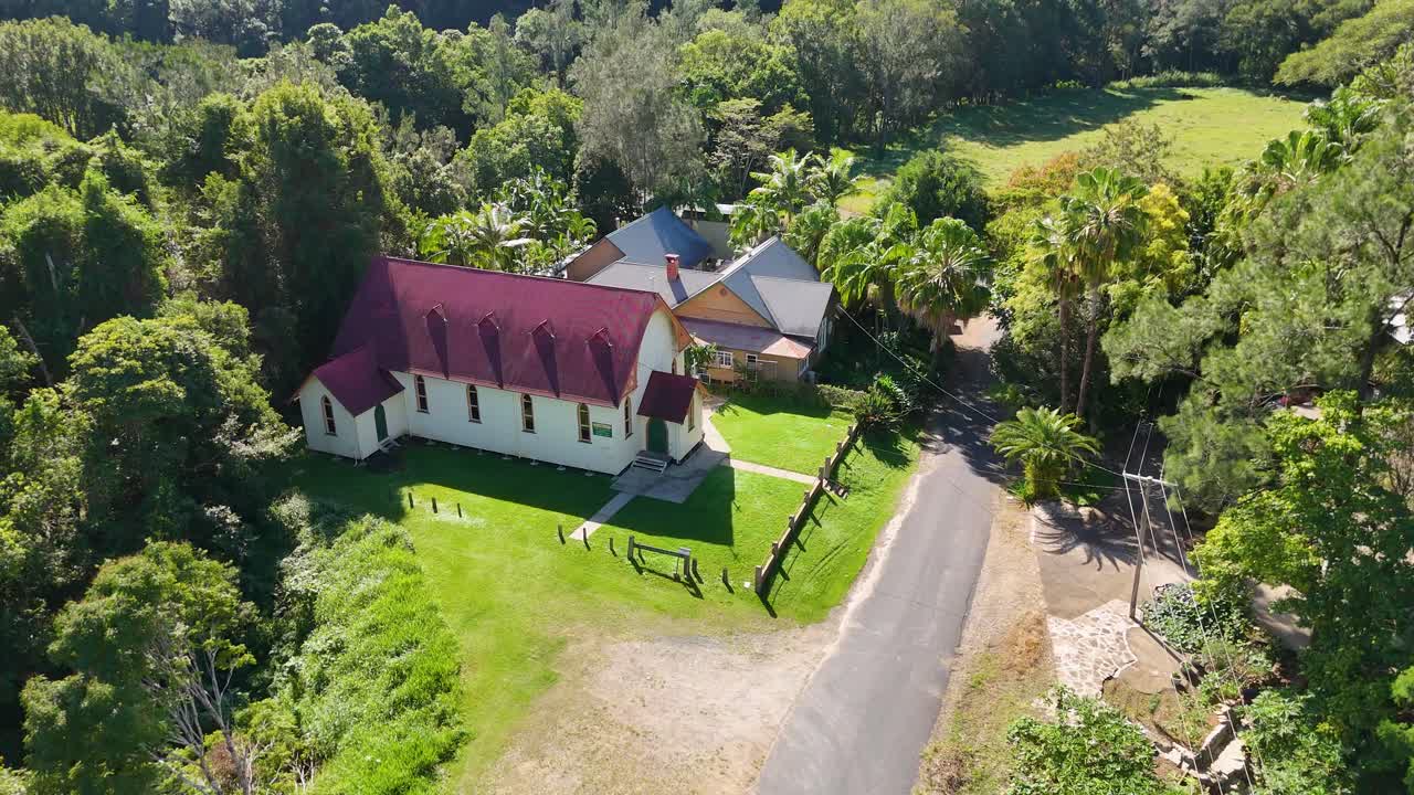 Aerial view of a rural church and buildings nestled in a valley