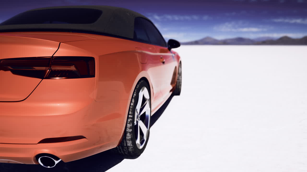 Orange convertible parked on a white salt flat under a blue sky