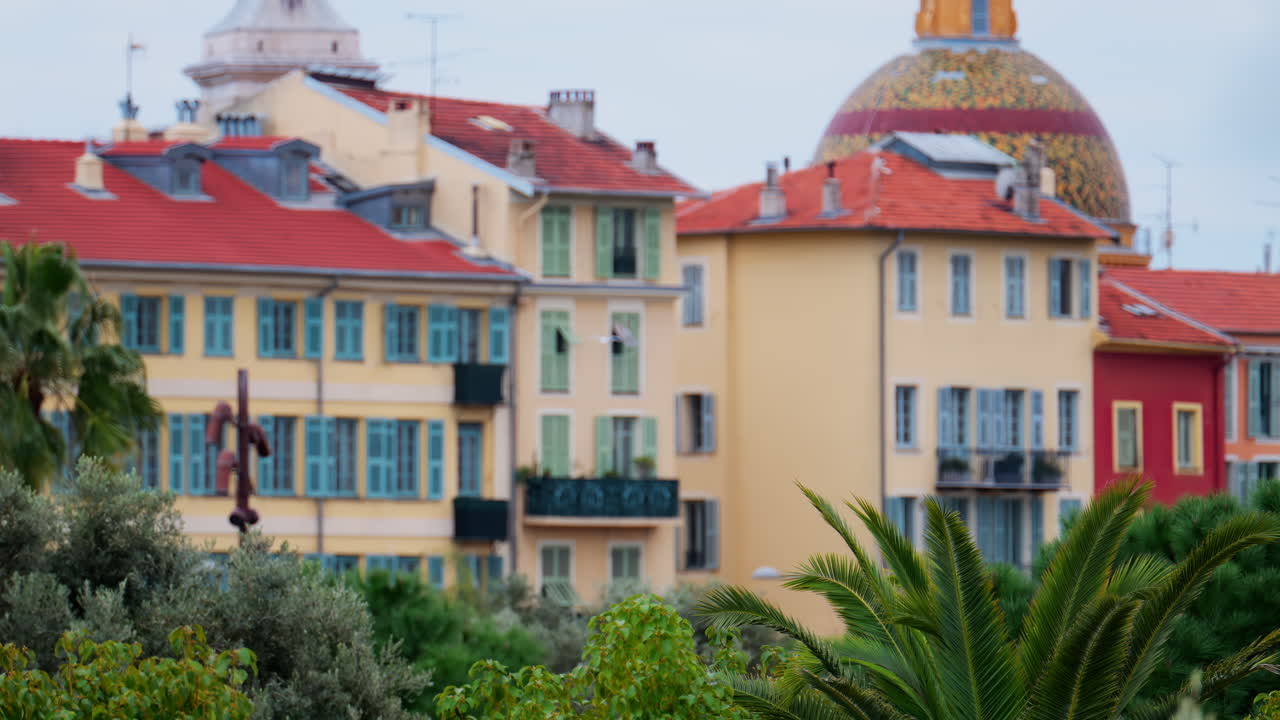 Colourful buildings and trees in the skyline of Nice, France on a cloudy day