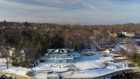 aerial slide to the left along the wintery shore of camden harbor