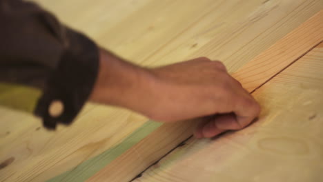 close-up of a carpenter measuring and inspecting wood