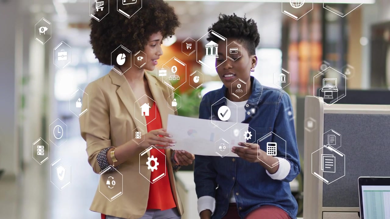 Coworkers sharing paper one pointing while other reading aligning office flow with hex UI hovering