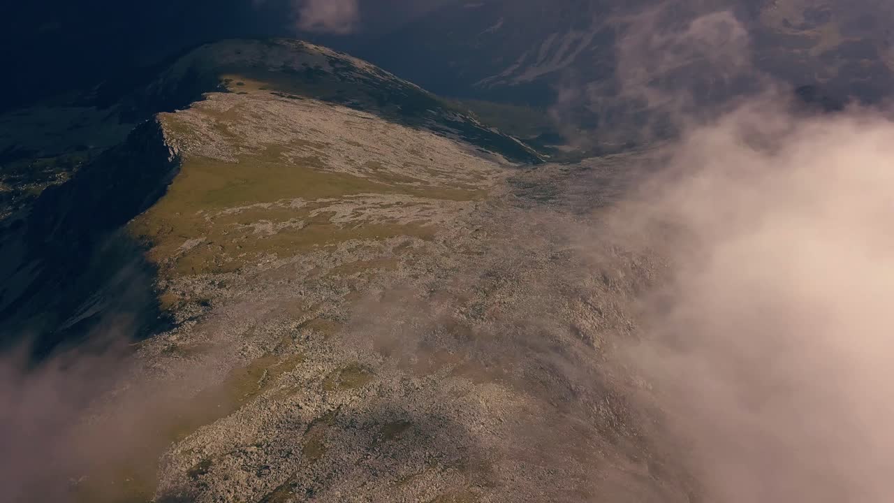 toma panorámica a través de las nubes con montañas debajo