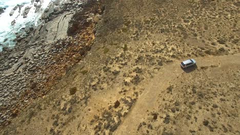 A-4WD-explores-a-rocky-4WD-track,-high-aerial