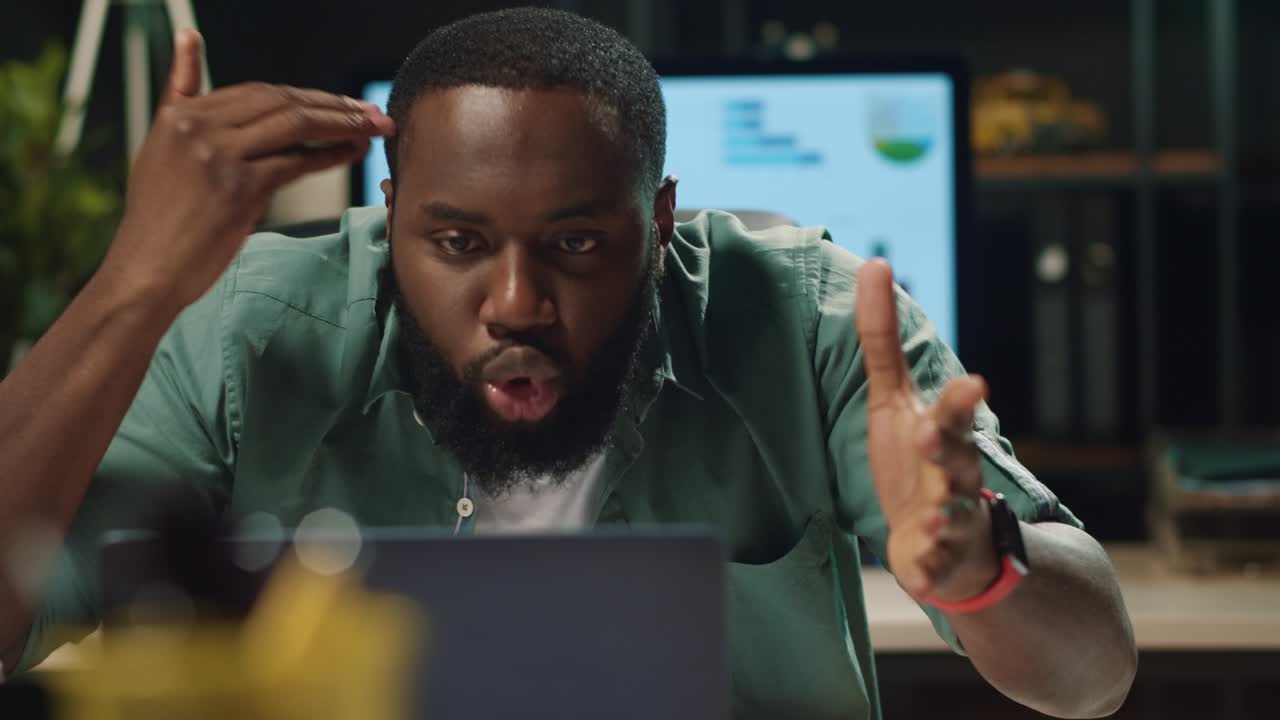 Closeup annoyed afro business man having video call in modern office
