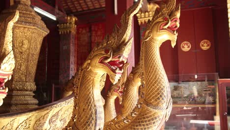 golden nagas serpent heads inside buddhist temple in luang prabang, laos traveling southeast asia