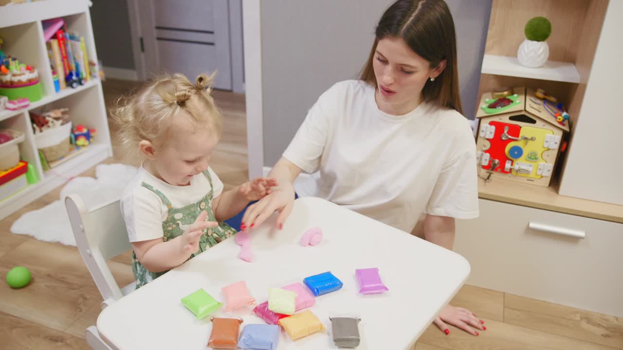 Mother and Toddler Playing with Colorful Playdough at Home