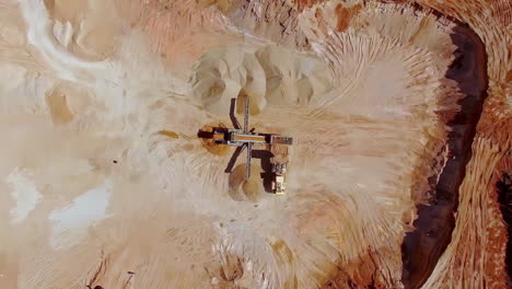 Awesome-Birdseye-view-of-an-industrial-loader-on-a-sandy-and-dusty-construction-site