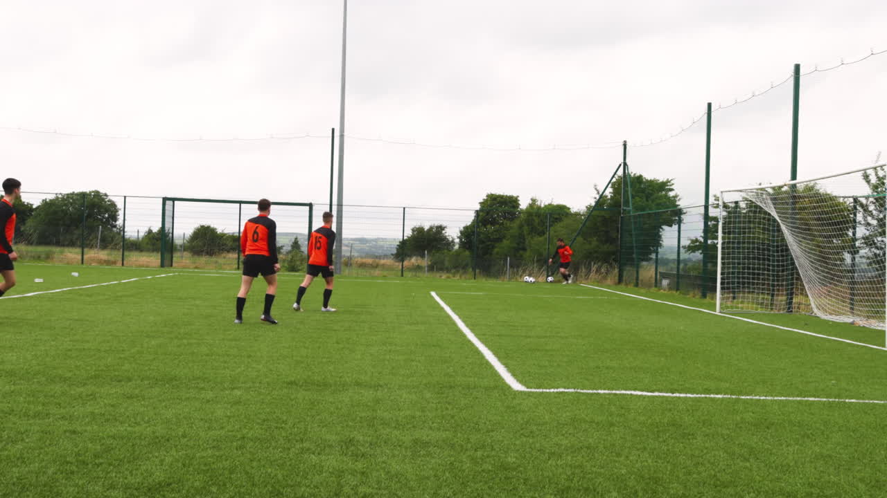 Soccer players practicing on field, preparing for corner kick during training