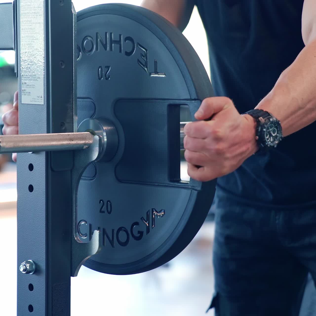 Muscular man doing training in gym. Fitness man bodybuilder training using barbell in gym