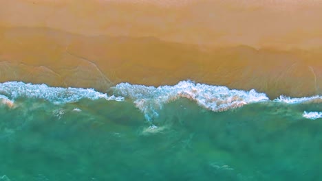 aerial view of a beautiful beach and turquoise ocean waves