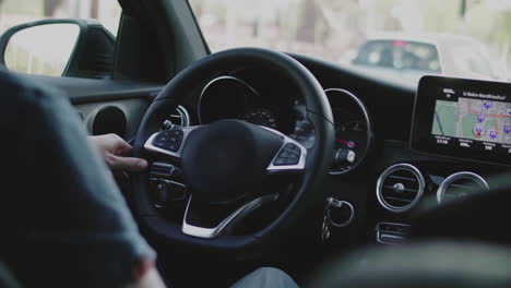Person Driving a Modern Car with GPS Navigation