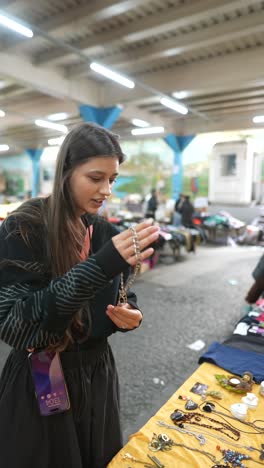 woman browsing jewelry at a market