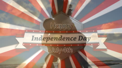 vídeo compuesto digital de feliz día de la independencia 4 de julio texto contra hombre llevando mujer