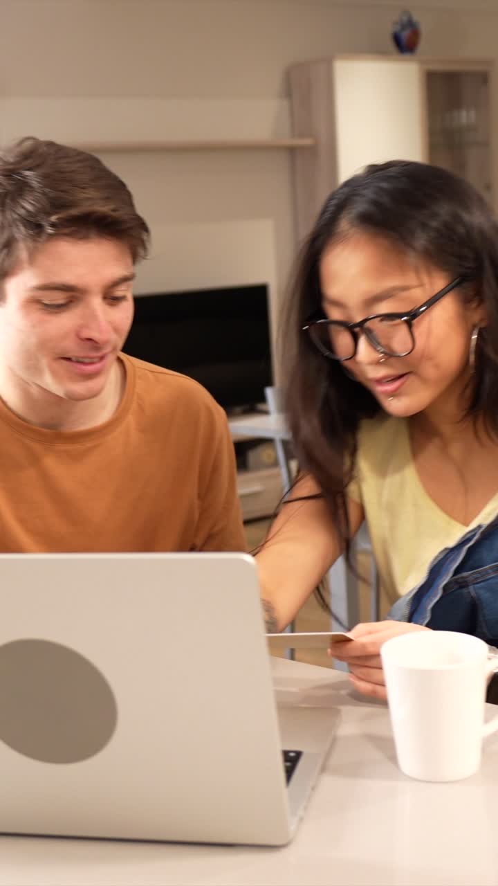 Couple shopping online with credit card