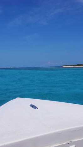pov sailing white vessel boat on caribbean sea water with tropical island background