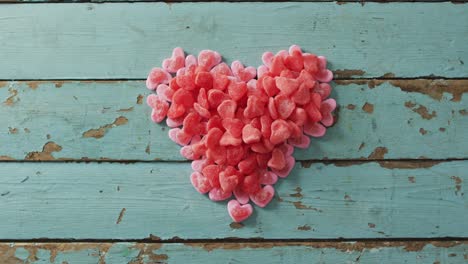 heart shape sweets on wooden background at valentine's day