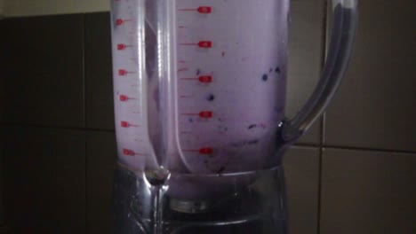 making a berry smoothie in a blender