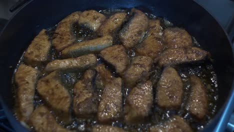 Close-Up-View-Of-Pieces-Of-Salmon-Fish-Sizzling-In-Oil-In-Pan