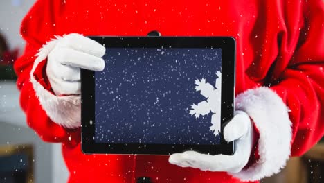 Videokomposition-Mit-Schnee-über-Dem-Oberkörper-Des-Weihnachtsmanns,-Der-Ein-Tablet-Hält