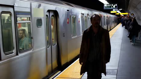 man waiting at subway station