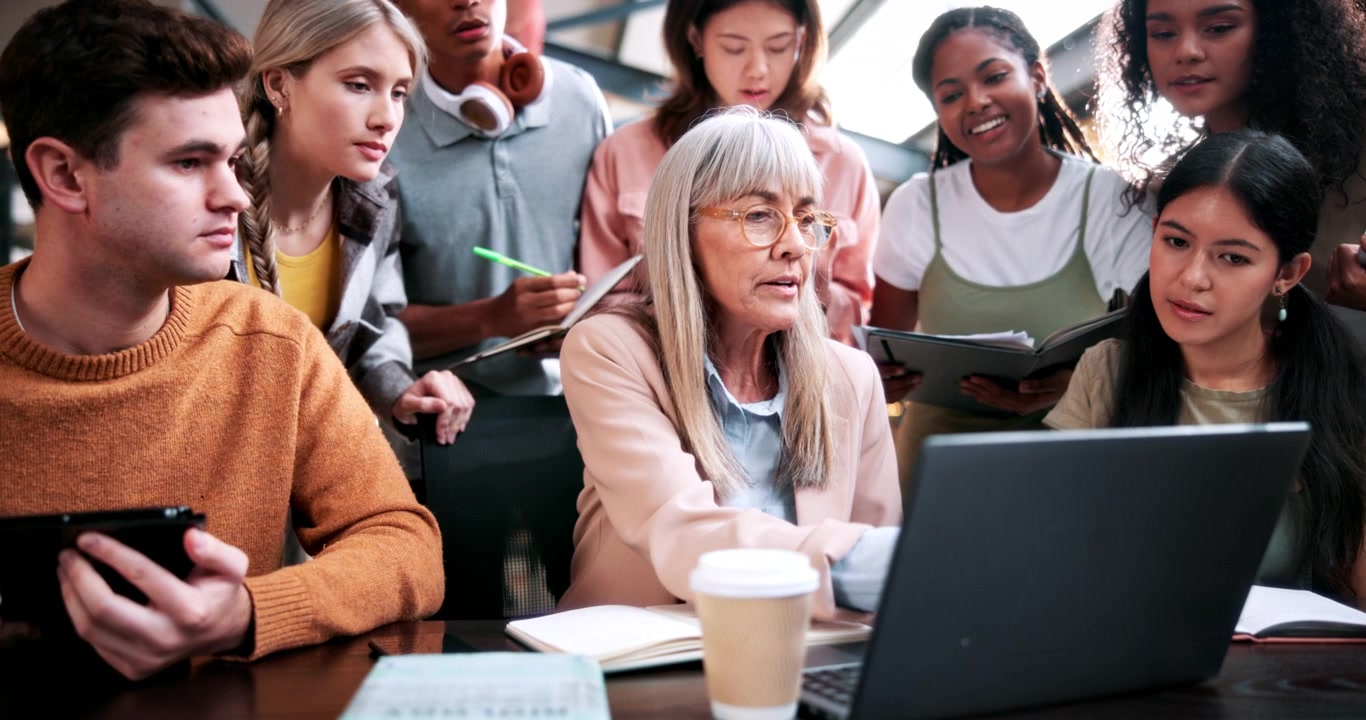 Senior Mentor Guiding Diverse Group of Students in Classroom