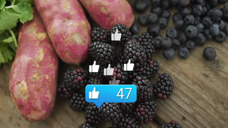 social media likes animation over fresh blackberries, blueberries, and sweet potatoes