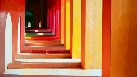 a row of colorful steps leading up to a red and yellow building