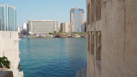 High-Rise-Buildings-Near-Dubai-Creek-In-Historical-Neighborhood-Of-Al-Fahidi,-Dubai-UAE---Handheld