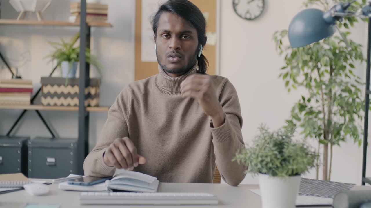Man in office setting, focused and ready for a video call